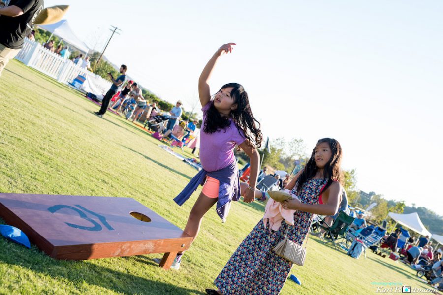 Playing cornhole at WestFest lawn games